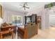 Living area with two sofas, a TV stand, and pool view at 30549 Pga Dr, Sorrento, FL 32776