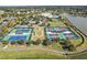 Community features tennis and pickleball courts, plus a clubhouse and lake at 8732 Providence Ct, Mount Dora, FL 32757