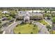 Community clubhouse with circular driveway and ample parking at 8732 Providence Ct, Mount Dora, FL 32757