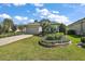 Single-story house with attached garage, landscaping, and paver driveway at 8732 Providence Ct, Mount Dora, FL 32757