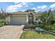 One-story home with a two-car garage, well-maintained landscaping and large driveway at 8732 Providence Ct, Mount Dora, FL 32757