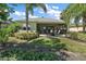 Home with covered patio, lush landscaping, and fenced-in backyard at 8732 Providence Ct, Mount Dora, FL 32757