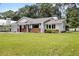 Single story home with brick and white accents, situated on a spacious lot at 26225 Troon Ave, Sorrento, FL 32776