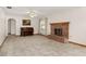 Spacious living room featuring a brick fireplace and tile floors at 26225 Troon Ave, Sorrento, FL 32776