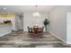 Open dining room with hardwood floors and a chandelier at 5701 Blanchard Ln, The Villages, FL 32163