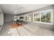 Sunroom with tiled floor, wicker chairs, and view at 5701 Blanchard Ln, The Villages, FL 32163