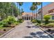 Elegant clubhouse entrance with palm trees and brick driveway at 1238 Glendora Rd, Kissimmee, FL 34759