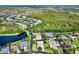 An aerial view of a neighborhood near a lake and conservation area at 1238 Glendora Rd, Kissimmee, FL 34759