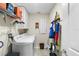 Bright laundry room with washer, dryer, shelving, and storage at 5120 Tanzanite Dr, Mount Dora, FL 32757