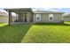 Large backyard with a screened porch and green lawn at 5120 Tanzanite Dr, Mount Dora, FL 32757