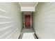 Inviting entryway with a red door and a charming 'HOME' sign at 5120 Tanzanite Dr, Mount Dora, FL 32757