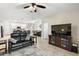 Open living space with a leather sectional, large TV, and view into the kitchen and dining area at 5120 Tanzanite Dr, Mount Dora, FL 32757