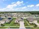 Aerial view of a house with a large backyard and neighborhood at 5120 Tanzanite Dr, Mount Dora, FL 32757