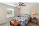 Bright bedroom featuring a window with blinds, a comfy bed and nightstands at 5120 Tanzanite Dr, Mount Dora, FL 32757