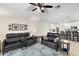 Comfortable living room with two leather sofas and a view of the kitchen at 5120 Tanzanite Dr, Mount Dora, FL 32757