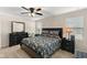 Main bedroom with a king-size bed, dresser, and nightstands at 5120 Tanzanite Dr, Mount Dora, FL 32757