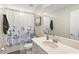 Clean bathroom with a shower/tub combo, single sink vanity and linen closet at 5120 Tanzanite Dr, Mount Dora, FL 32757