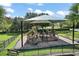 Shaded playground with modern playset and benches at 5120 Tanzanite Dr, Mount Dora, FL 32757