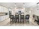 Modern kitchen with white cabinets, an island with seating, and stainless steel appliances at 5120 Tanzanite Dr, Mount Dora, FL 32757