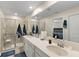 Modern bathroom with double sinks, shower, and a comfortable sitting area at 5120 Tanzanite Dr, Mount Dora, FL 32757