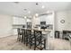 Modern kitchen with white cabinets, an island with seating, and stainless steel appliances at 5120 Tanzanite Dr, Mount Dora, FL 32757