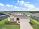 Single-story home with gray siding, red shutters, and a two-car garage at 5120 Tanzanite Dr, Mount Dora, FL 32757