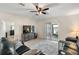 Spacious living area with a comfy leather sectional and sliding glass doors leading to a patio at 5120 Tanzanite Dr, Mount Dora, FL 32757