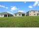 Large grassy backyard with views of neighboring homes at 1565 Tali Ln, Mount Dora, FL 32757