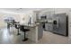 Modern kitchen with gray cabinets, granite countertops, and stainless steel appliances at 1565 Tali Ln, Mount Dora, FL 32757
