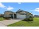 Gray one-story house with white garage door at 1565 Tali Ln, Mount Dora, FL 32757