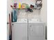 Laundry room with washer, dryer, and overhead shelving at 1565 Tali Ln, Mount Dora, FL 32757