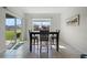 Bright dining room with table and chairs, and sliding glass doors to backyard at 1565 Tali Ln, Mount Dora, FL 32757