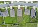 Aerial view of houses on a residential street with green lawns and driveways at 1565 Tali Ln, Mount Dora, FL 32757