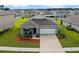 Aerial view of a gray house in a neighborhood at 1565 Tali Ln, Mount Dora, FL 32757