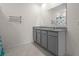 Double vanity bathroom with granite countertop and gray cabinets at 1565 Tali Ln, Mount Dora, FL 32757
