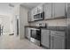 Kitchen with gray cabinets and stainless steel appliances at 1565 Tali Ln, Mount Dora, FL 32757