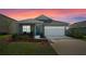Gray one-story house with white garage door at 1565 Tali Ln, Mount Dora, FL 32757