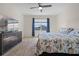 Bright bedroom with king-size bed, dresser, and window with blue curtains at 1565 Tali Ln, Mount Dora, FL 32757