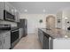 Modern kitchen with gray cabinets and granite countertops at 1565 Tali Ln, Mount Dora, FL 32757