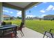 Covered patio overlooking a large backyard at 1565 Tali Ln, Mount Dora, FL 32757