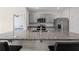 Modern kitchen with breakfast bar and granite countertops at 1565 Tali Ln, Mount Dora, FL 32757