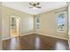 Bright bedroom with hardwood floors, ceiling fan, and large windows at 34416 Tuscany Ave, Sorrento, FL 32776