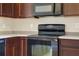 Black electric range and microwave in modern kitchen at 34416 Tuscany Ave, Sorrento, FL 32776