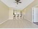 Breakfast bar with three stools, view into kitchen and hallway at 34416 Tuscany Ave, Sorrento, FL 32776