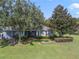 Landscaped backyard with patio and lush greenery at 34416 Tuscany Ave, Sorrento, FL 32776