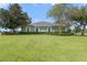 Private backyard with lush lawn and mature trees at 34416 Tuscany Ave, Sorrento, FL 32776