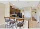 Kitchen with dark wood cabinets, black appliances, and a breakfast bar at 34416 Tuscany Ave, Sorrento, FL 32776