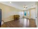 Spacious living room with hardwood floors and a piano at 34416 Tuscany Ave, Sorrento, FL 32776