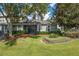 Landscaped backyard with a spacious patio and lush greenery at 34416 Tuscany Ave, Sorrento, FL 32776