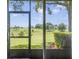 Relaxing screened patio overlooking a lush green golf course at 34416 Tuscany Ave, Sorrento, FL 32776